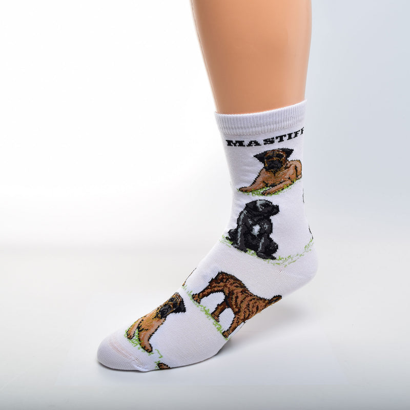 For Bare Feet Mastiff Poses Sock has a White background. Mastiff, is in Bold Black Print under the Cuff. The Poses are on Green Grass. The first Pose is an Apricot with Black Mask Mastiff Laying Down. Then a Black Mastiff with White Markings Sitting. A Brindle Mastiff in a Stance is the Last and the pattern begins to repeat.