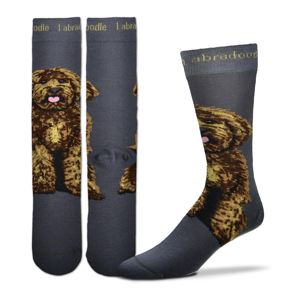 For Bare Feet Realistic Labradoodle Sock starts on a Charcoal background. Labradoodle is in Buff color in the Cuff spelled out. The Labradoodle Dog is sitting below the Heel and above the Heel going up your ankle towards your knee. He is all fluffy in fur. He is happy with a Pink Tongue and bright eyes looking out at you.