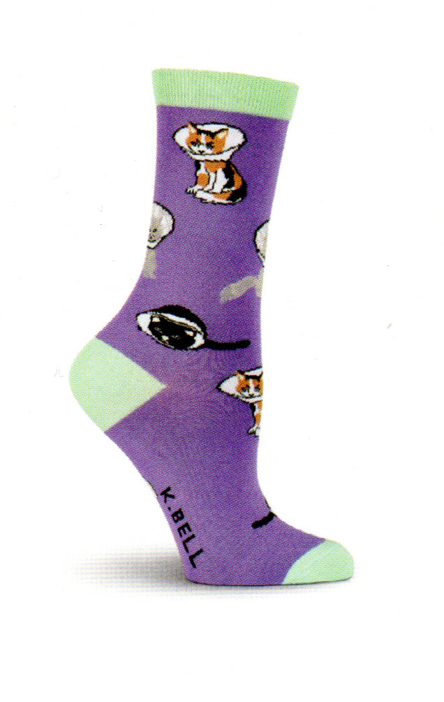 K Bell Cone Cats Socks begins on a Purple background with a Medium Aquamarine for Cuffs, Heels and Toes. The Cats are Calico Cats, Greys and Blacks. For whatever reason the poor kitties are wearing Cones.
