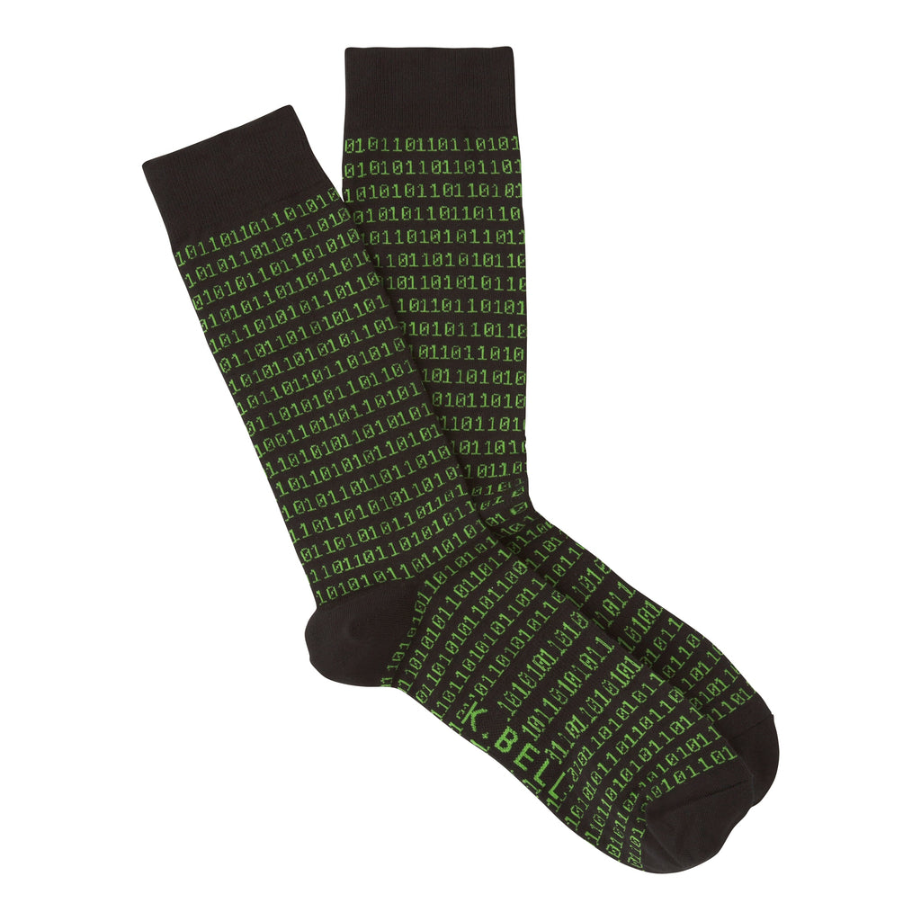K Bell Mens Binary Tech Sock starts on a Black background. In a Bright Green glow begins a long series of Ones and Zeros. It starts right below the Cuff and forms around the Heel and stops at the Toes. It is a Sock to give the Binary Techs their Due.