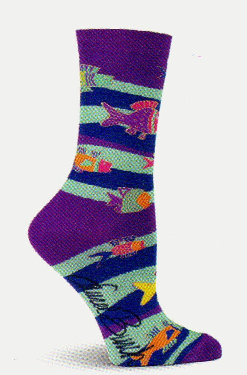 On a background of Purple starts Laurel Burch Fish and Waves Sock. Below the Cuff are Ribbons of Cyan and Indigo. Fish of different sizes swim along the Ribbons. They are Purple, Cyan, Magenta, Coquelicot and Saffron with Gold Thread for detail on the Fish.