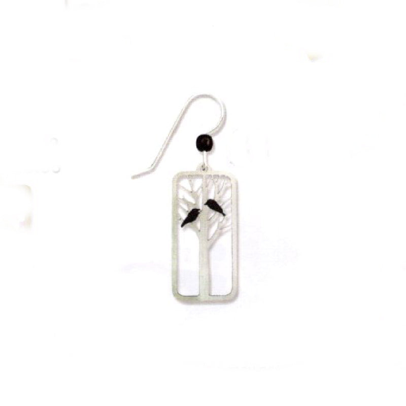 Silver earrings with tree design and Ravens on a white background
