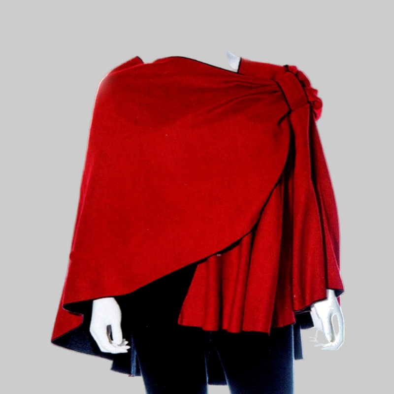 A bright red draped Cashmere Shawl or Cape styled garment displayed on a white mannequin against a plain white background.