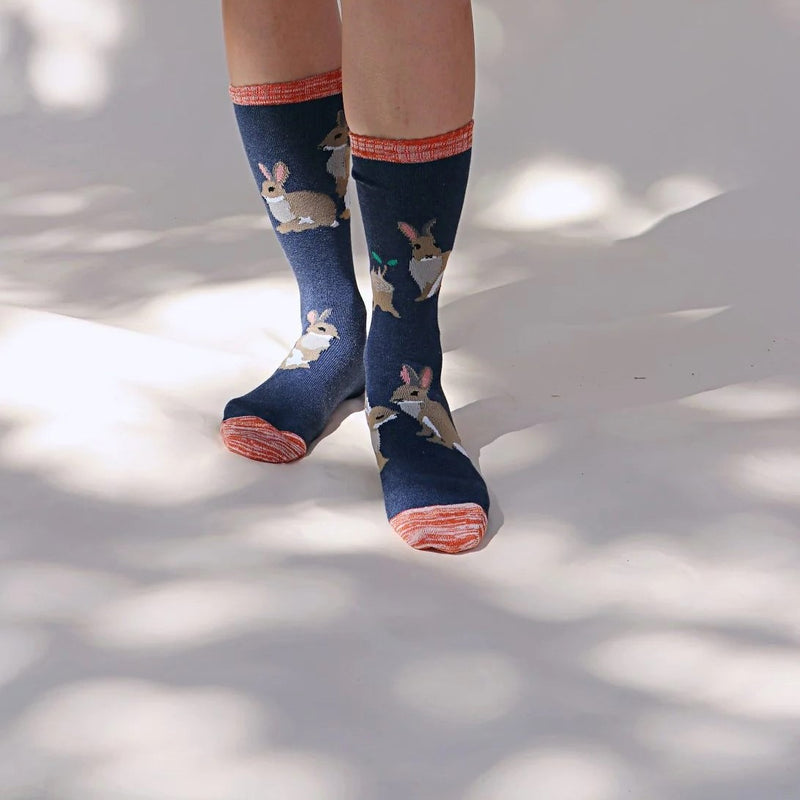 This is the Denim Tabbisocks Bunny Rabbit Replant Pairs Ca  Socks. Denim is the background, colors of Reds and Browns are in the majority.