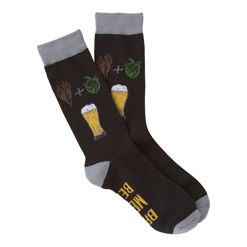 This is K Bell American Made Mens Beer Sock. Starts on a background of Black. The Cuffs, Heels and Toes are Charcoal Grey. Below the Cuff are a Sprig of Barely a Plus Sign and Hops to make the Beer below. The Beer in the Glass is Golden with White Foam on Top. In the Arch of the foot reads, "Bring Me A Beer" in Golden Text.