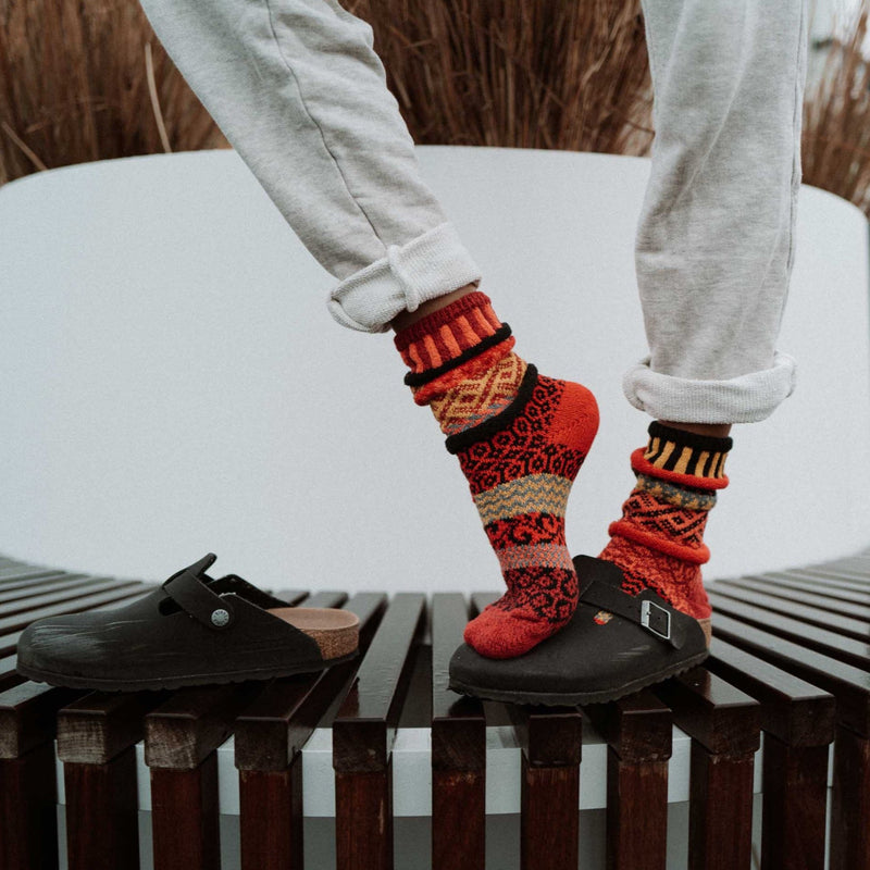 Solmate Adult Crew Fire Sock shows well against White Pants this Model is wearing.
