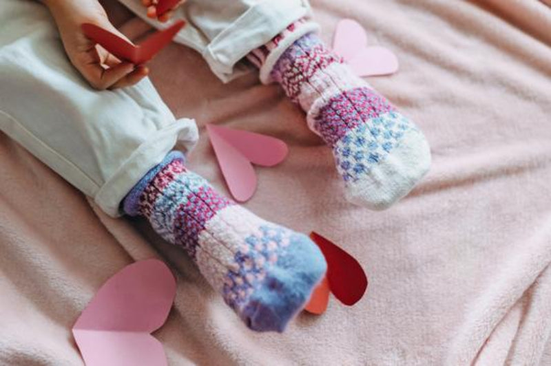 Solmate Kids Crew Lovebug Sock is Mismatched on Purpose and this shows a pair on a Model. 